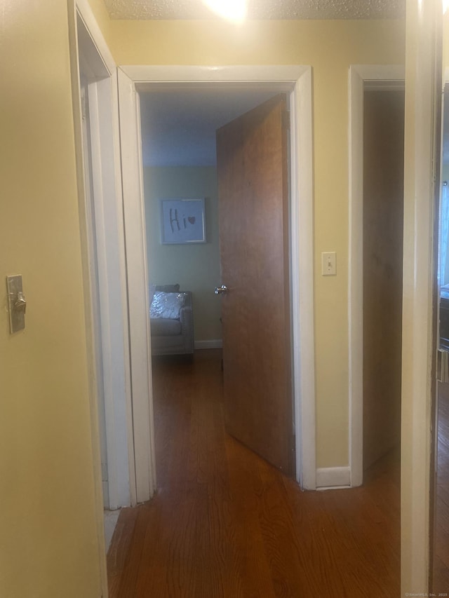 corridor with hardwood / wood-style floors