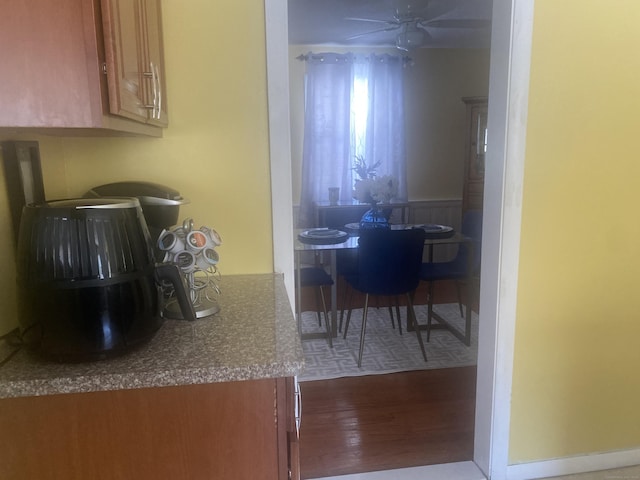 kitchen with hardwood / wood-style floors and ceiling fan