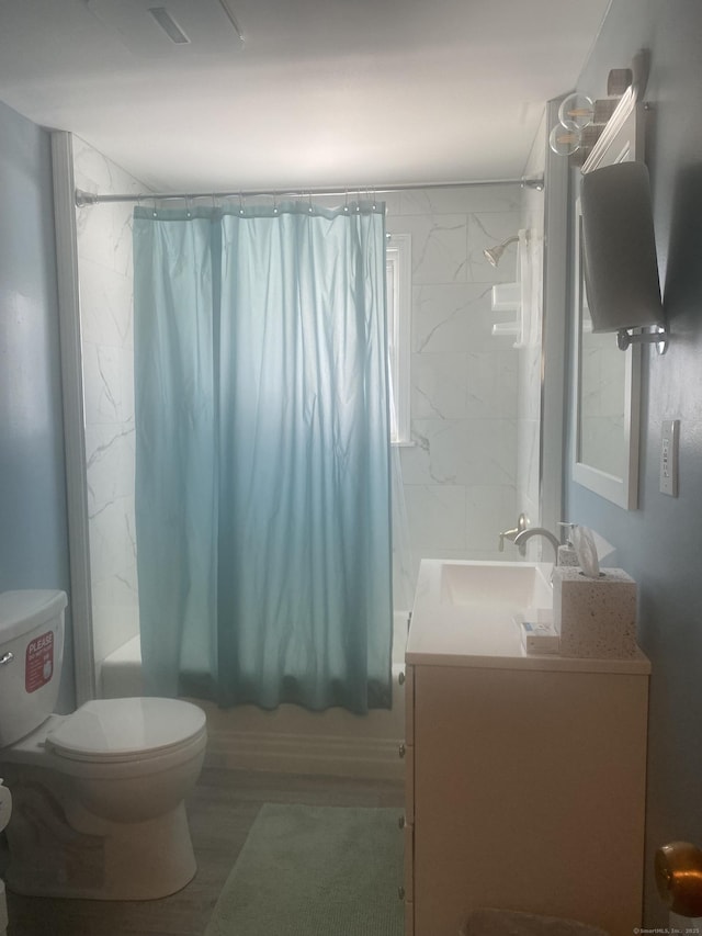 full bathroom with vanity, shower / tub combo, and toilet