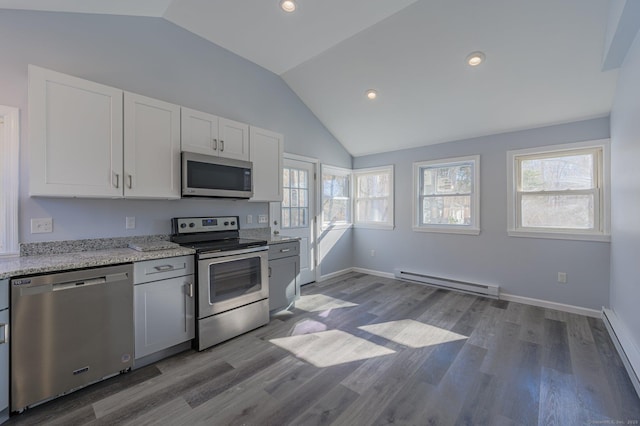 kitchen with stainless steel appliances, white cabinetry, and a baseboard heating unit