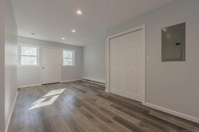 entryway with a baseboard radiator, electric panel, and dark hardwood / wood-style flooring