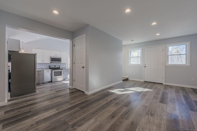 foyer entrance featuring lofted ceiling and dark wood-type flooring