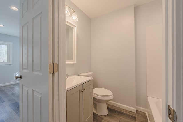 bathroom featuring hardwood / wood-style flooring, vanity, and toilet