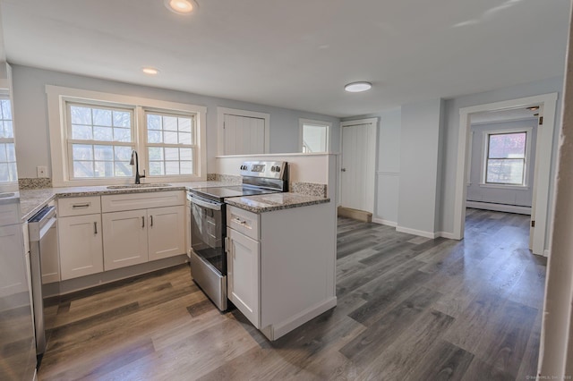 kitchen featuring sink, appliances with stainless steel finishes, white cabinetry, light stone countertops, and a baseboard radiator