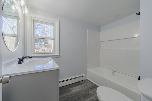 full bathroom with toilet, wood-type flooring, tub / shower combination, a baseboard radiator, and vanity