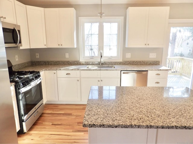 kitchen featuring stainless steel appliances and white cabinets