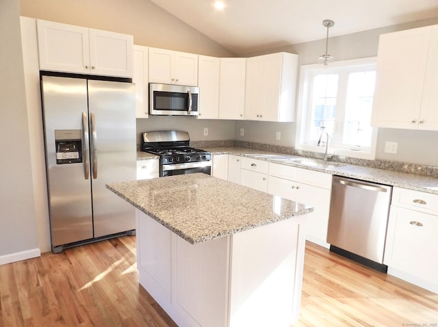 kitchen with stainless steel appliances, decorative light fixtures, and white cabinets