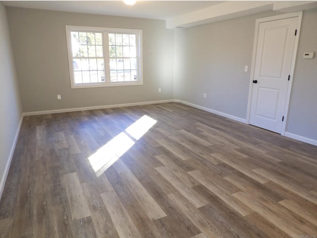 spare room featuring dark wood-type flooring