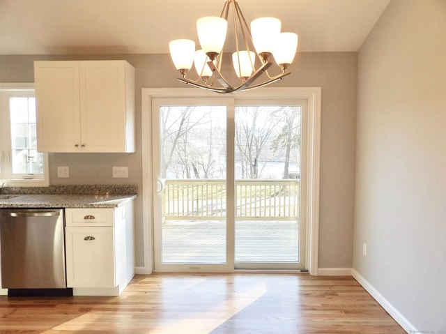 kitchen with pendant lighting, dishwasher, white cabinetry, stone countertops, and light wood-type flooring