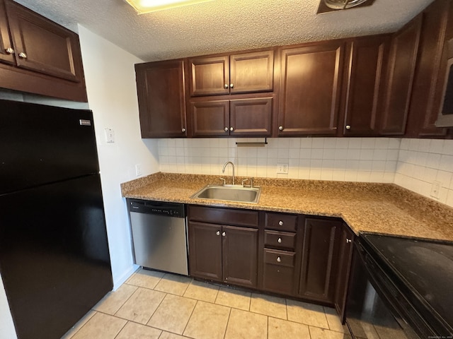 kitchen with sink, a textured ceiling, light tile patterned floors, decorative backsplash, and black appliances