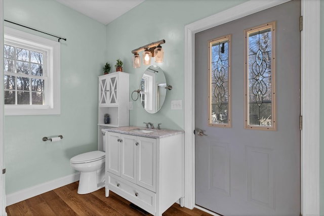 bathroom with vanity, wood-type flooring, and toilet