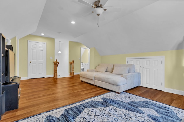 living room featuring lofted ceiling, wood-type flooring, and ceiling fan