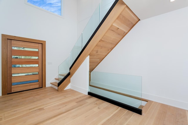 entryway featuring lofted ceiling and light wood-type flooring