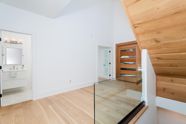 interior space with hardwood / wood-style flooring and high vaulted ceiling