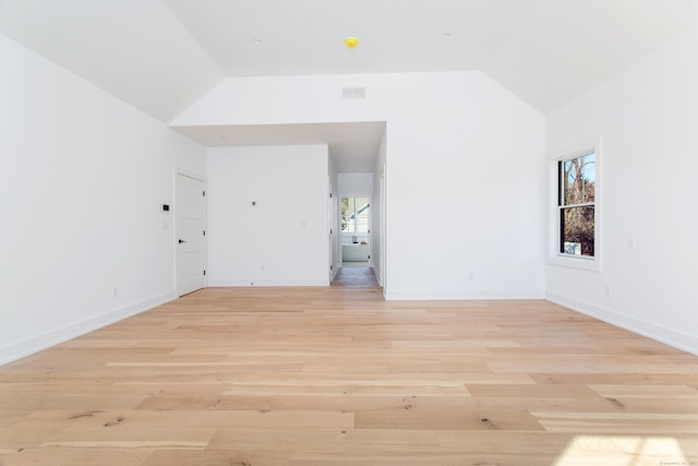 interior space featuring lofted ceiling and light hardwood / wood-style floors