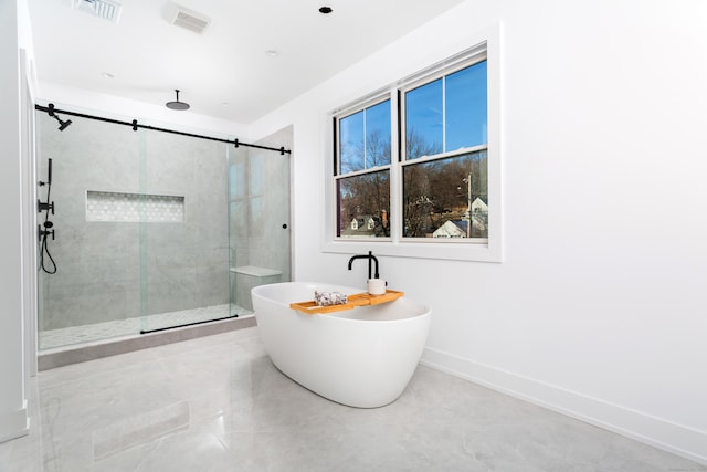 bathroom featuring tile patterned flooring and shower with separate bathtub