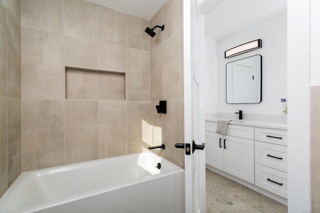 bathroom featuring vanity and tiled shower / bath