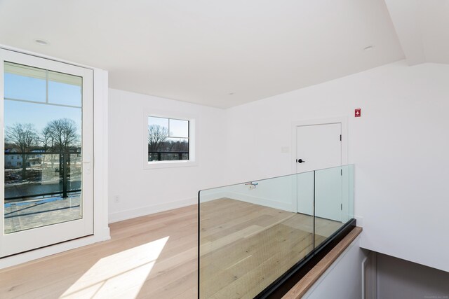 staircase featuring hardwood / wood-style flooring and vaulted ceiling