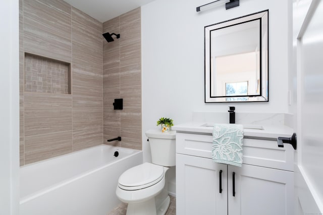 full bathroom featuring tiled shower / bath combo, vanity, and toilet