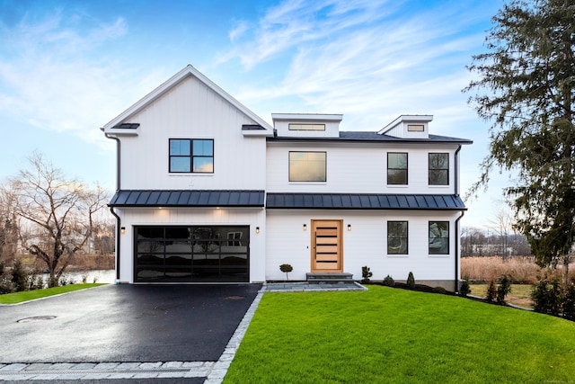 modern farmhouse style home with a garage and a front lawn