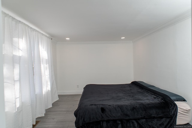 bedroom featuring light hardwood / wood-style flooring and ornamental molding