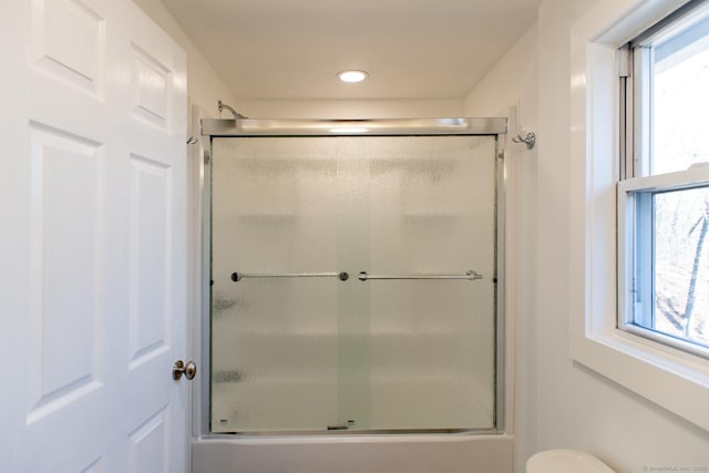 bathroom featuring plenty of natural light and toilet