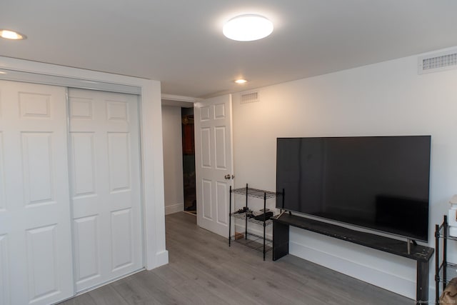 bedroom featuring a closet and light wood-type flooring