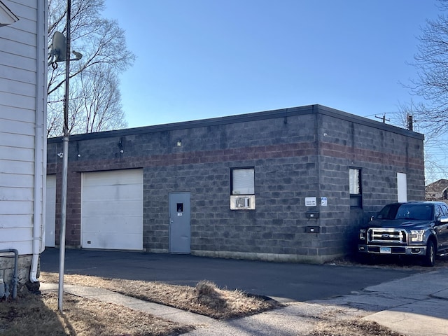 exterior space featuring a garage and cooling unit