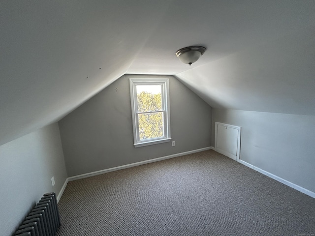 bonus room featuring lofted ceiling, radiator, and carpet floors