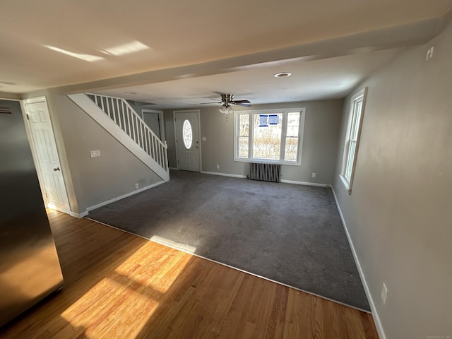 interior space with radiator, hardwood / wood-style floors, and ceiling fan