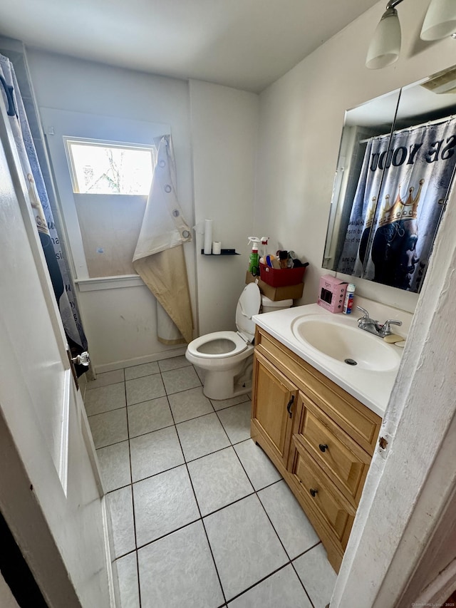 bathroom with vanity, toilet, and tile patterned flooring