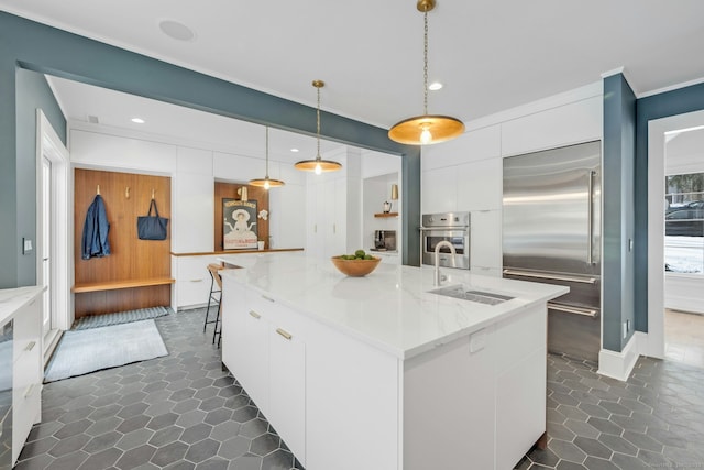 kitchen with a spacious island, white cabinetry, a sink, modern cabinets, and built in refrigerator