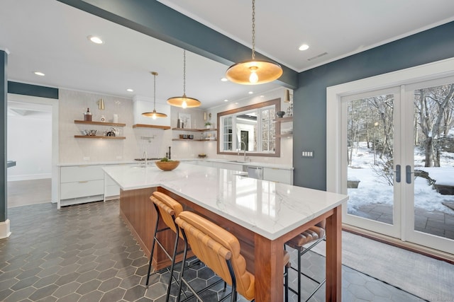 kitchen featuring pendant lighting, open shelves, white cabinetry, modern cabinets, and dishwasher