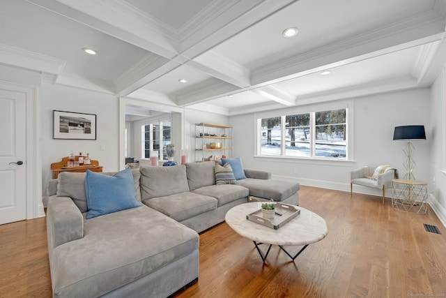 living room featuring visible vents, wood finished floors, and beam ceiling