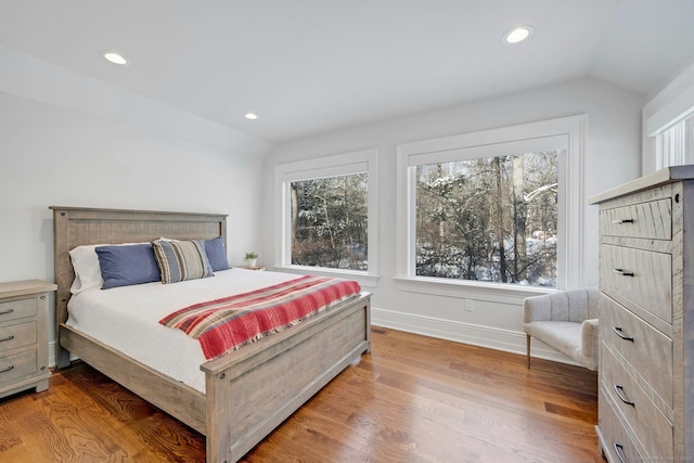 bedroom featuring lofted ceiling, light wood-type flooring, baseboards, and recessed lighting