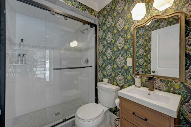 full bathroom with toilet, ornamental molding, a stall shower, vanity, and wallpapered walls