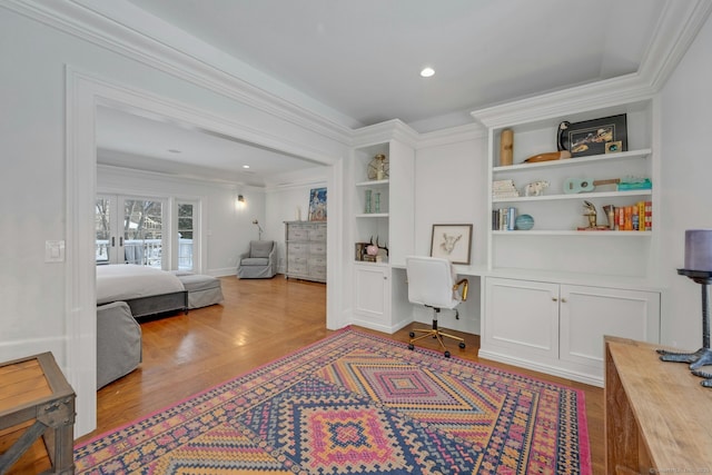 bedroom featuring ornamental molding, wood finished floors, built in study area, and recessed lighting