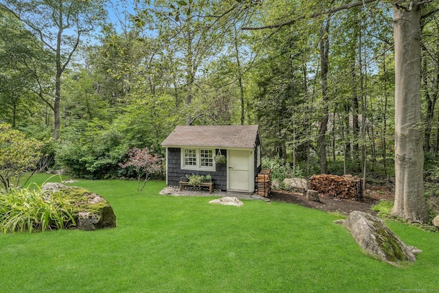 view of front of house featuring a front yard, an outbuilding, and a shed