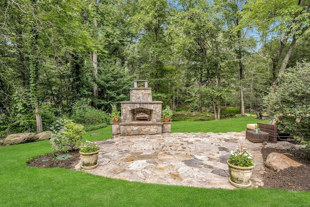 view of patio with an outdoor stone fireplace