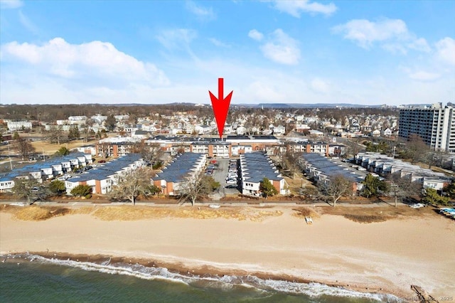 birds eye view of property featuring a beach view and a water view