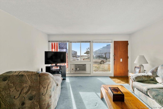 carpeted living room featuring cooling unit and a textured ceiling