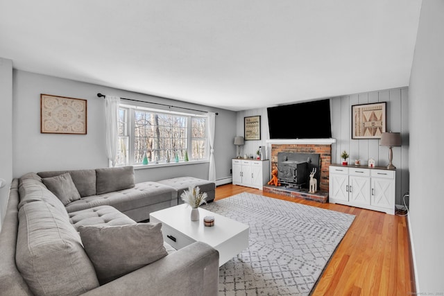 living room featuring light wood-type flooring and baseboard heating