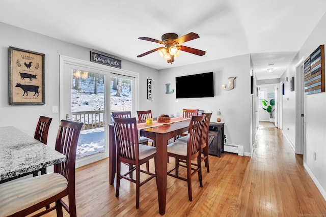 dining space with a baseboard radiator, light hardwood / wood-style floors, and ceiling fan