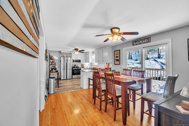 dining room featuring ceiling fan and light hardwood / wood-style floors