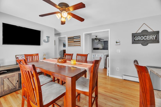 dining room with ceiling fan, a baseboard heating unit, and light hardwood / wood-style floors