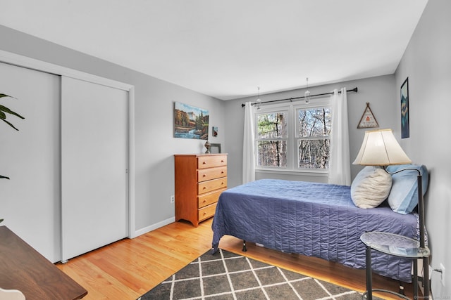 bedroom featuring hardwood / wood-style floors and a closet