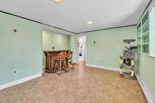 interior space with a baseboard radiator and indoor bar