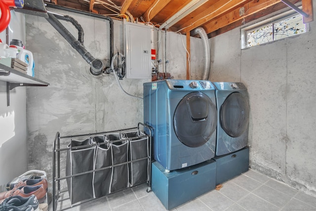 laundry room with separate washer and dryer, electric panel, and light tile patterned floors