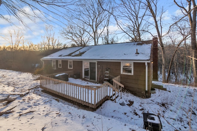 view of snow covered rear of property