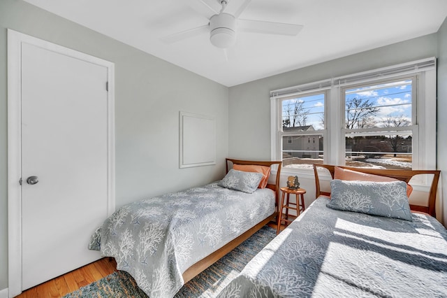 bedroom with ceiling fan and wood-type flooring